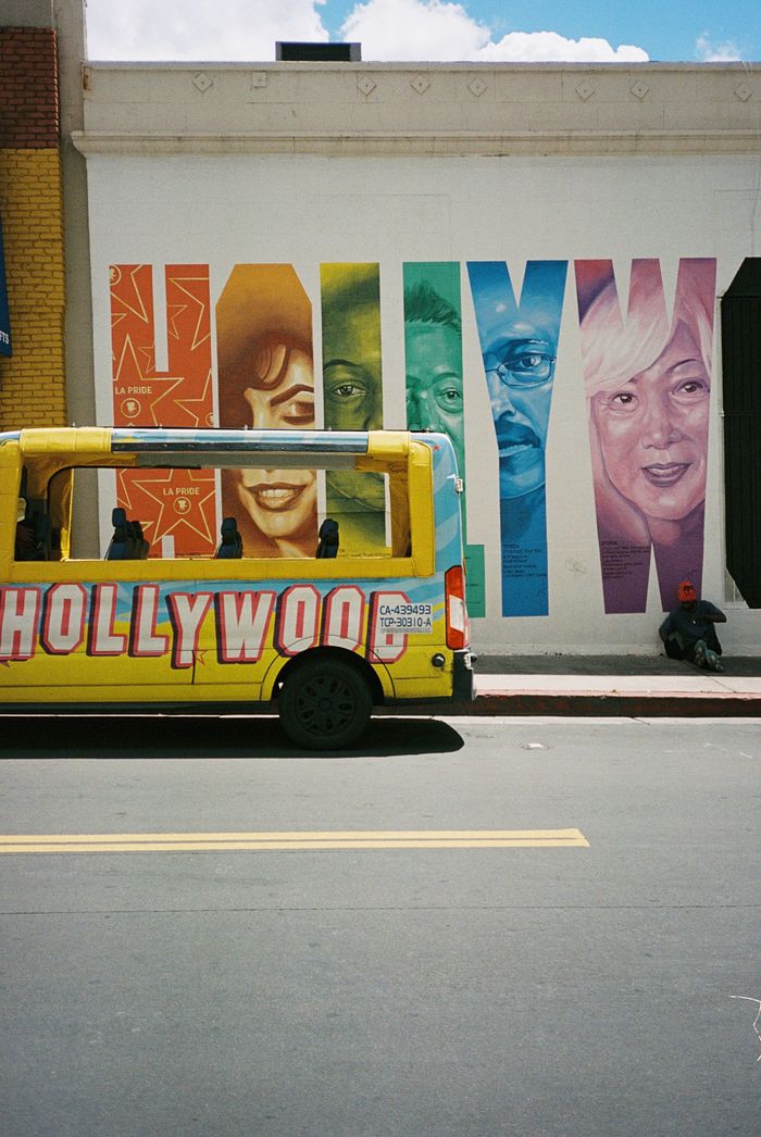 Vibrant Hollywood mural and bus on sunny Los Angeles city street.